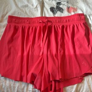 coral shorts, has pockets on each side,  flowy material